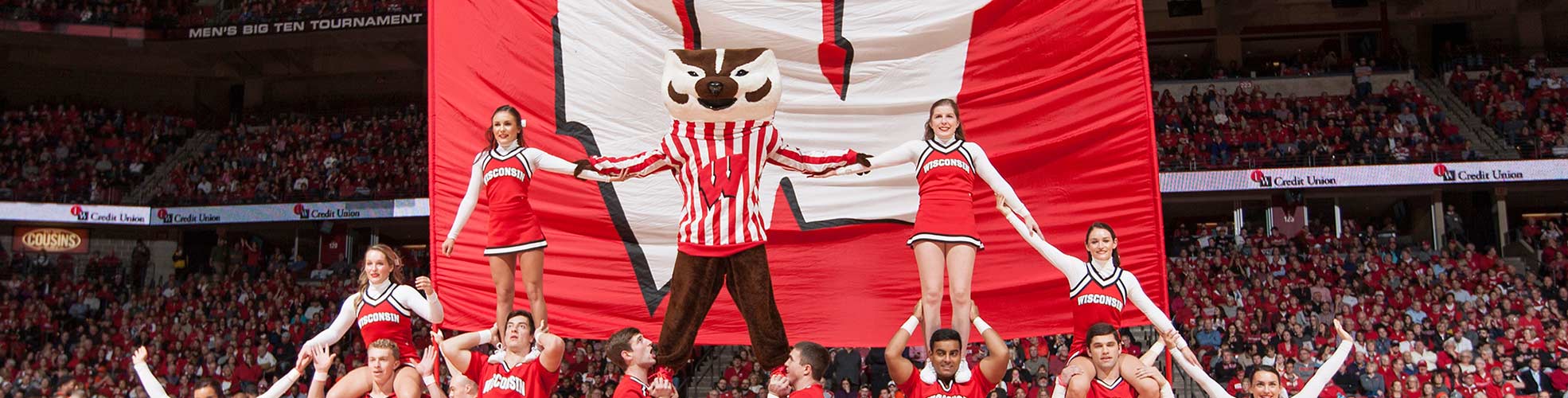 A Photo of UW-Madison's Bucky Badger and the UW Spirit Squad at a Men's Basketball Game Forming a Pyramid'